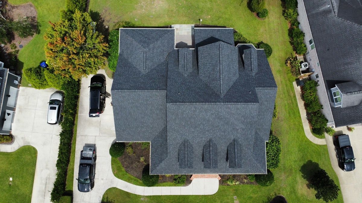 A new charcoal shingle roof seen straight down from a drone